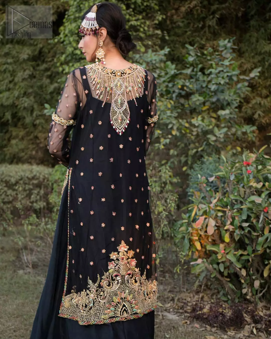 This elegant ensemble turns timeless piece into a chic fantasy. Steal the show with this endearing chiffon outfit with intricate yet rich embroidery. Artfully crafted neckline with detailed golden zardozi work. The hemline is ornamented with a central large motif and adorned with jaal. Furthermore, side slits are also decorated with floral embroidery and floral motifs are decorated with multiple color thread embroidery. The back is perfectly loaded with zardozi work. This outfit is comprises with black sharara and chiffon dupatta having sequins spray all over.