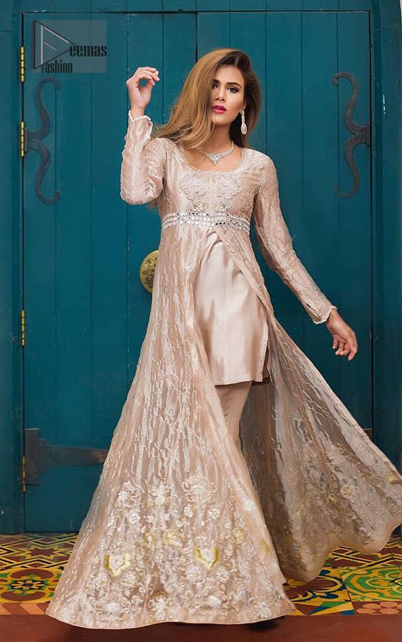 This dress is majestic beauty. Delicately crafted and personifying chic elegance with an element of grandiose. The gown is beautifully decorated with floral bunches done with silver kora, dabka, tilla and sequins work. The bottom of the gown is enhanced with rich floral embroidery. Style it up with hand embellished fixed waist belt. It comprises with cameo straight pantsa. This outfit is coordinated with chiffon dupatta having sequins spray all over.