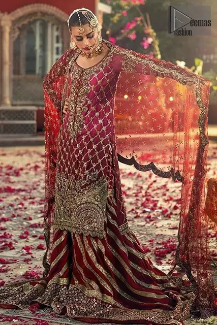 This elegant ensemble turns timeless piece into a chic fantasy. Crafted artfully with detailed work on border and traditional neckline finessed with kora, dabka and kundan. Shirt is furthermore enhanced with geometric patterns and scalloped lace hemline. It comprises with red sharara with embellished detailed bottom and gotta work. Style it up with red chiffon dupatta focusing on kora and dabka handwork scalloped borders on all four sides and sprinkled sequins on all over.
