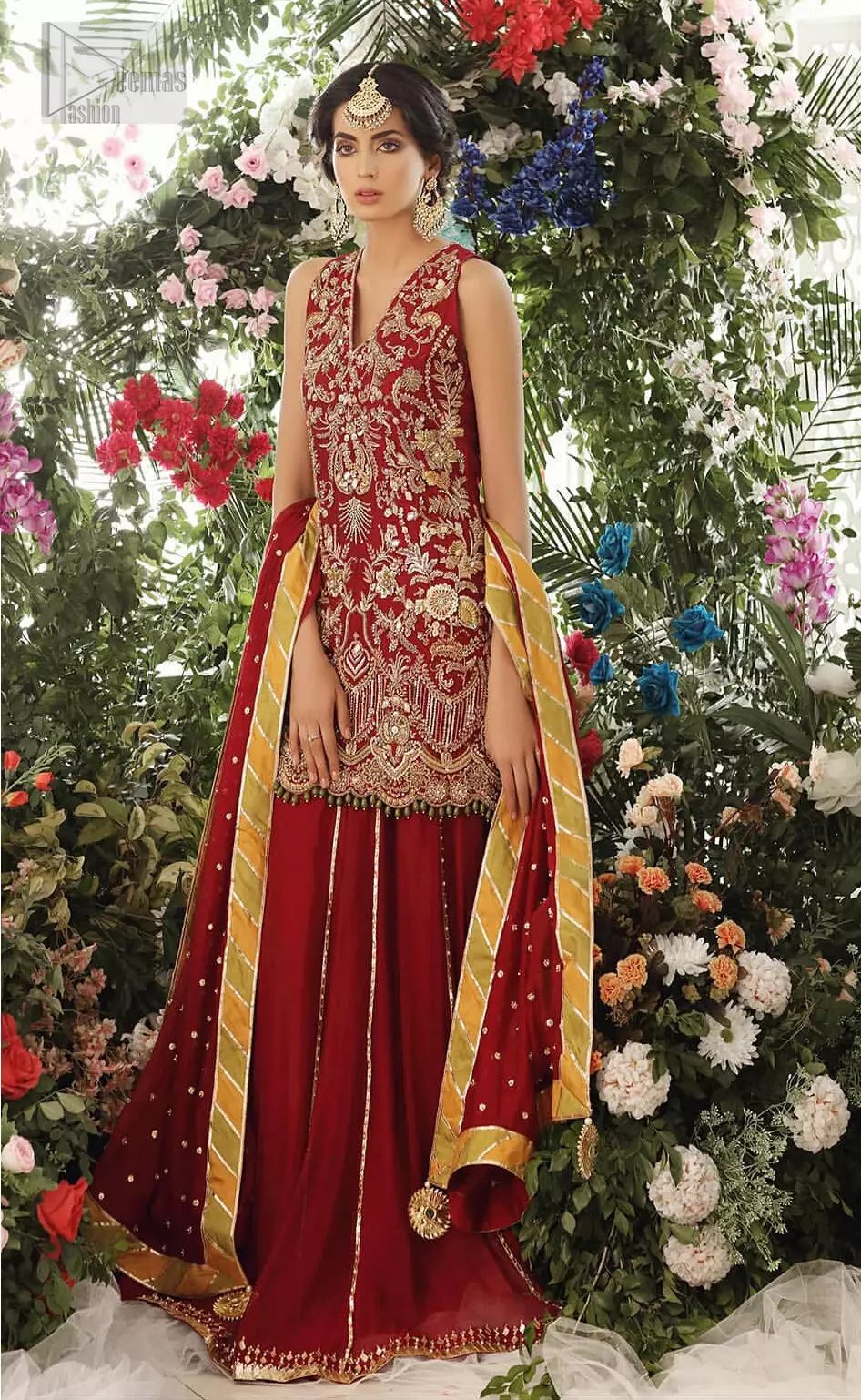 Tradition meets modernity. Boost your confidence and style in this glamorous attire accentuated with finest zardozi work embroidery and scalloped borders with dandling pearls. This maroon sleeveless shirt is ornamented with golden and light golden zardozi work. The scalloped hemline is decorated with dangling pearls. Style it confidently with maroon sharara adorned with beautiful gota work. It is paired with an ethereal maroon dupatta with scattered sequins all over and four sided applique borders.