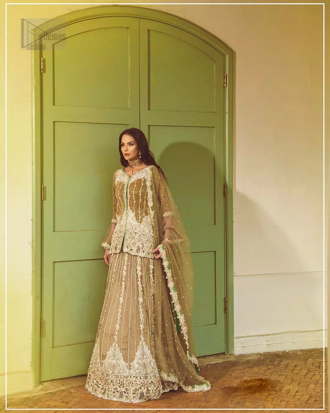 Let the crowd stare and make it worth their while when you walk wearing this outfit. Designed to flaunt your best features, the front open shirt carries intricate embellishment on the hemline and neckline. Complete the look with artfully coordinated lehenga which is ornamented with a bold and captivating design with a traditional intricate embroidery. Furthermore the lehenga and shirt is also emphasized with silver embroidered vertical lines. The fawn net dupatta with chann and scalloped finishing all around the edges makes the look complete. Upholding the idea of simple is beautiful, you would definitely want to wear this for your next occasion.