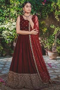 Let the crowd stare and make it worth their while when you walk wearing this maroon velvet lehenga blouse. Designed to flaunt your best features, the sleeveless blouse carries sequins spray with round neckline. Upholding the idea of simple is beautiful, you would definitely want to wear this for your next occasion or on your big day. The blouse is paired with maroon lehenga with hand embellishments on velvet base. The wide flare lehenga hemline is emphasized with intricate details with antique shaded kora, dabka, tilla and sequins work that gives the perfect ending t this outfit. Paired with maroon net dupatta having lace on all four sides.