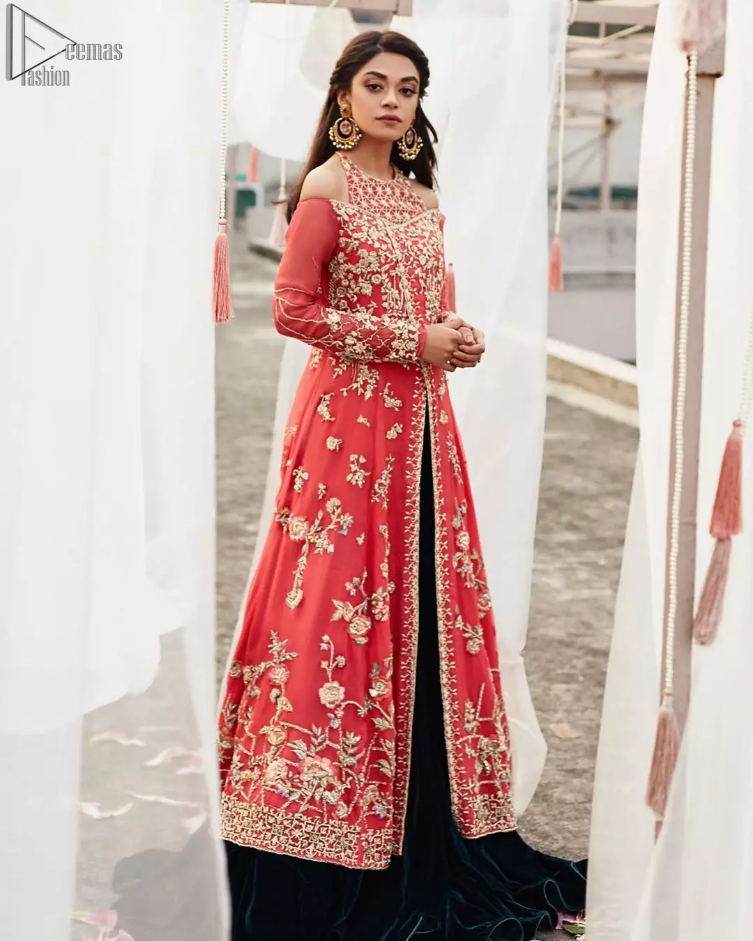 This outfit brings drama and playfulness to traditional frock and Sharara with a modern approach. Drape yourself to perfection for the classic affair in this flattering front open ensemble festooned with intricate zardozi hand embroidery work and motifs. The frock is furthermore adorned with halter neckline and comprises with overlaped bodice. Embellishment is done with zardozi embroidery in silver color. This outfit is comprises with bottle green velvet sharara and coral chiffon dupatta with sequins spray all over.