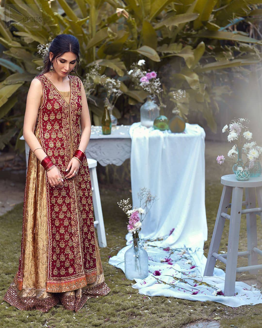 Impeccably on trend, this chic, romantic and oh-so-elegant ensemble is perfect for the one who want to mix vintage touches in with more daring and contemporary designs. Unique craftsmanship and detailed embellishments on the maroon front open shirt, done with golden zardozi. Furthermore the back of the shirt is also emphasized with zardozi work and scattered sequins all over the back. It comprises with golden inner maxi enhanced with maroon embellished applique on the bottom. Pair it up with golden brocade churidar pajama and golden crushed dupatta.