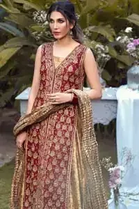 Impeccably on trend, this chic, romantic and oh-so-elegant ensemble is perfect for the one who want to mix vintage touches in with more daring and contemporary designs. Unique craftsmanship and detailed embellishments on the maroon front open shirt, done with golden zardozi. Furthermore the back of the shirt is also emphasized with zardozi work and scattered sequins all over the back. It comprises with golden inner maxi enhanced with maroon embellished applique on the bottom. Pair it up with golden brocade churidar pajama and golden crushed dupatta.