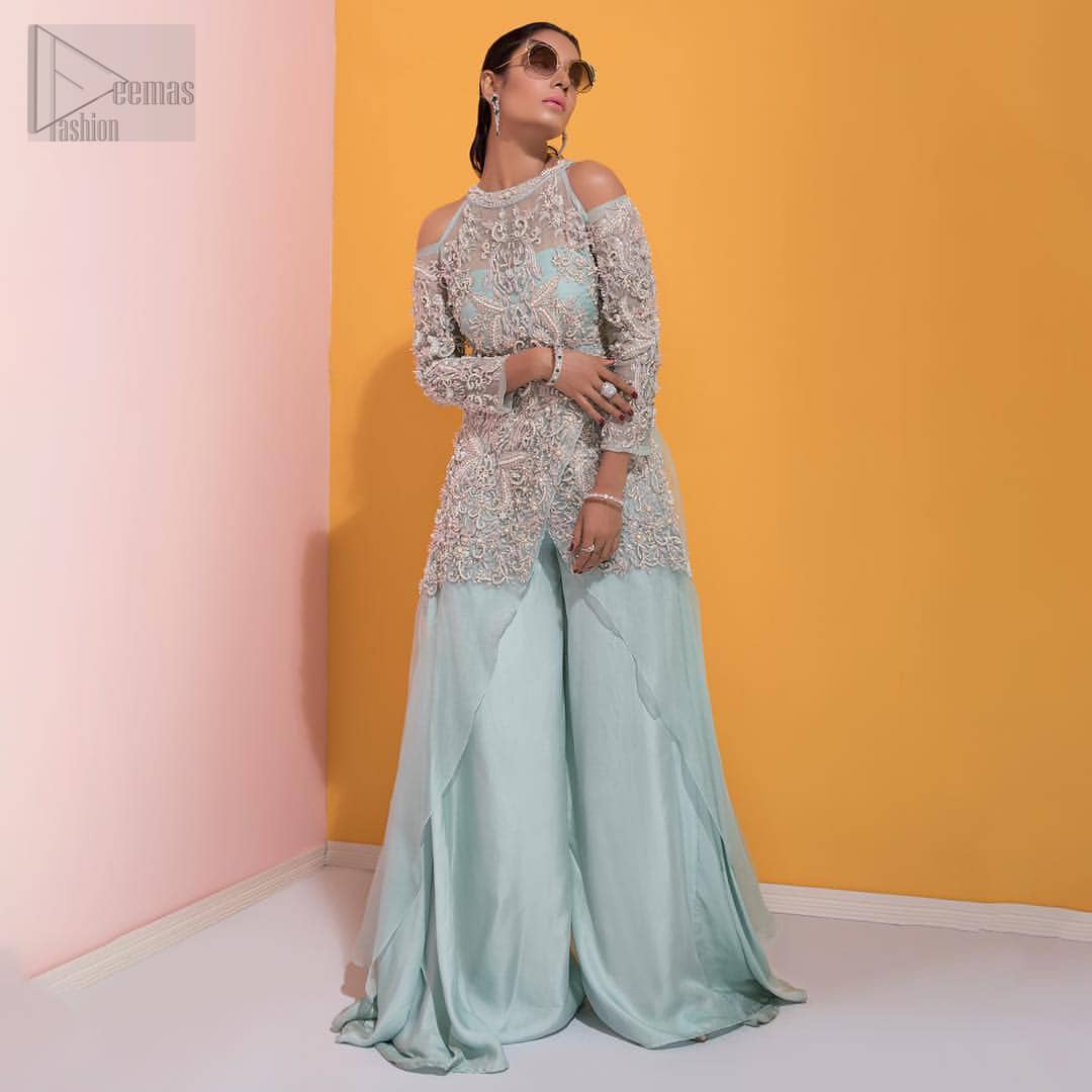 A fashion forward style statement that is contemporary yet chic. This handcrafted remarkable ensemble includes art deco design elements. Unique craftsmanship and detailed embellishments on the pastel green shirt creating delicate yet flamboyant pieces of art in your wardrobe collection. Cold Shoulder sleeves and halter illusion neckline make it more remarkable. To complete the look, go with palazzo pants and organza dupatta sprinkled with sequins all over.