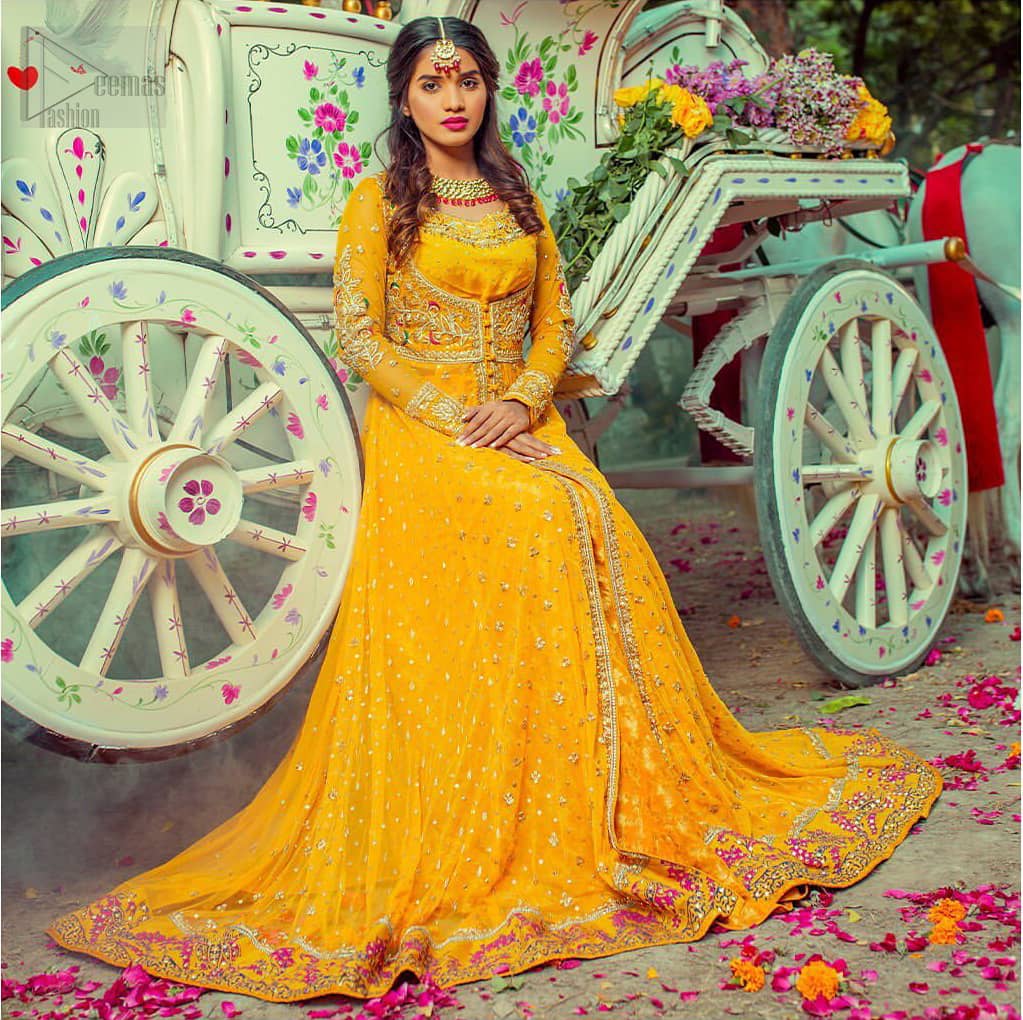 Adorn yourself with this breath-taking mehndi outfit. Be it the next mehndi right after a family festivity. A delicate arrangement of hand embellished tiny floral motifs on the ground and heavily embellished from bodice and neckline with golden and pink zardozi work. The daaman is emphasized with intricate zardozi details and multiple color thread work that gives perfect ending to this outfit. Pair it up with yellow churidar pajama. To complete the look, go with yellow chiffon dupatta scattered with tiny floral motifs and kiran on all four sides.