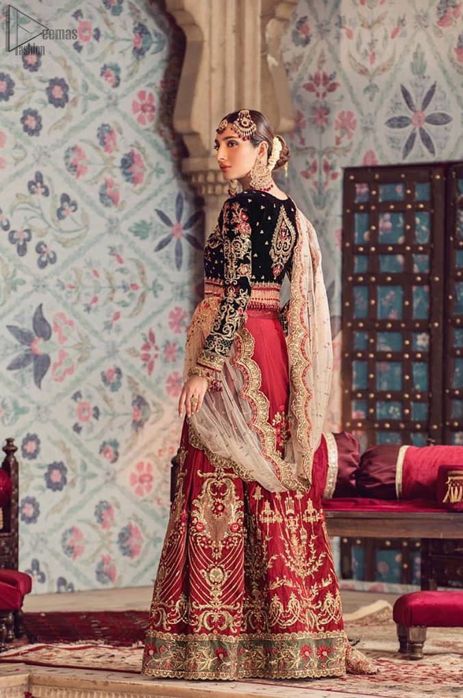 The new season is all about making a statement. Captured in traditional silhouette, The bridal stands out due to its uniqueness and the perfect fusion of modern cut and traditional embroidery. Black velvet blouse is beautifully decorated with multiple colour embroidery and finished with tassels. It comes with full embellished velvet lehenga adorned with applique all around the edges and motifs all over it. This outfit is coordinated with beige net dupatta which is sprinkled with sequins all over it. It is further furnished with a four-sided scalloped border.