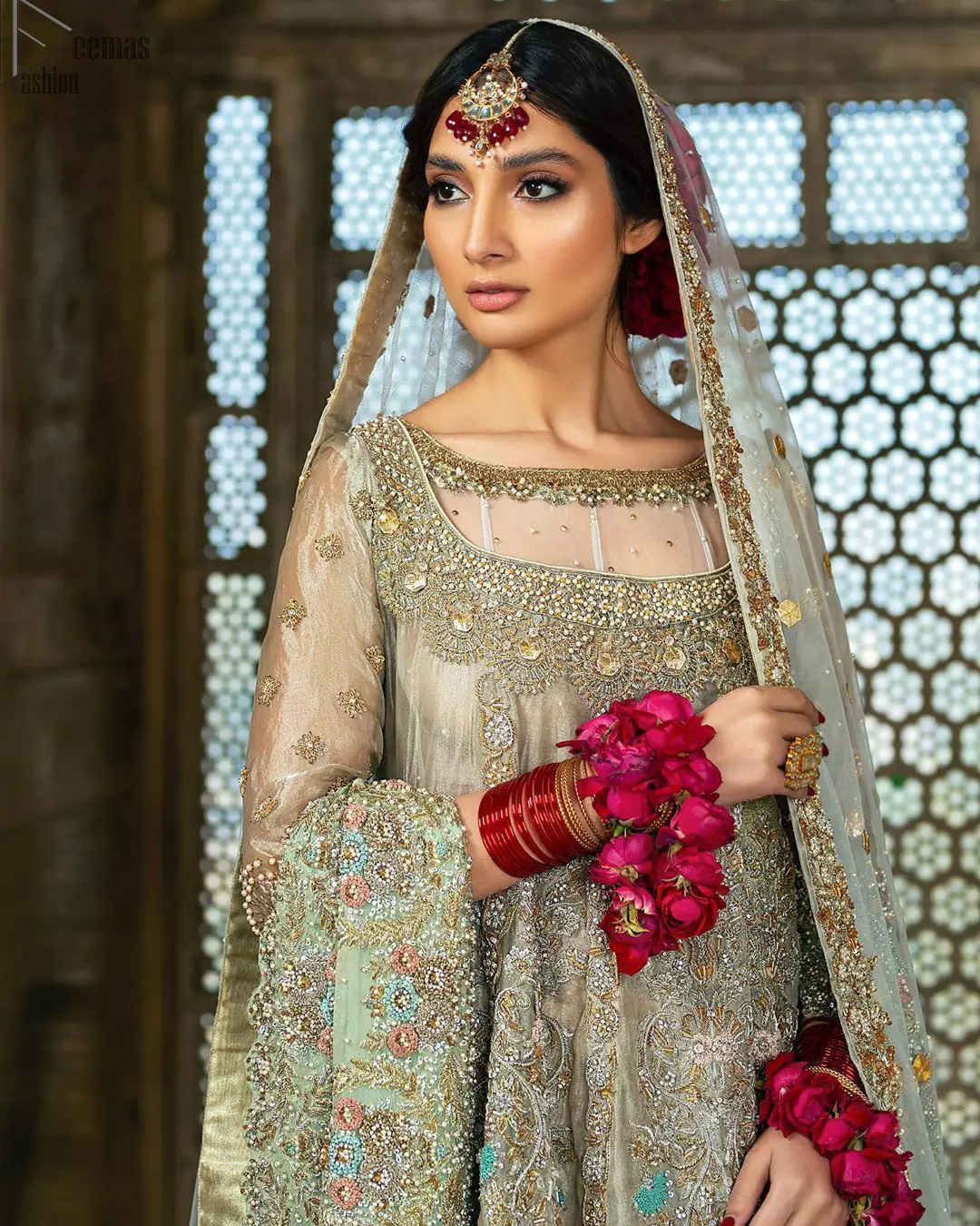 Pastel Green Double Layer Frock - Tea Rose Sharara. Fabulously stitched, Pastel Green double flared frock in maxi style is exquisite indeed. Fully embellished with tilla, dabka, sequins, pearls and silk thread embroidery. The frock body is entirely composed of pure organza with one part round neckline. Frock comes with three-quarter sleeves and it is concealed with a side zip closure. Tea rose pure tissue sharara with decently composed with fixed waist belt with side zip closure is one to wear on nikah or on a wedding day.