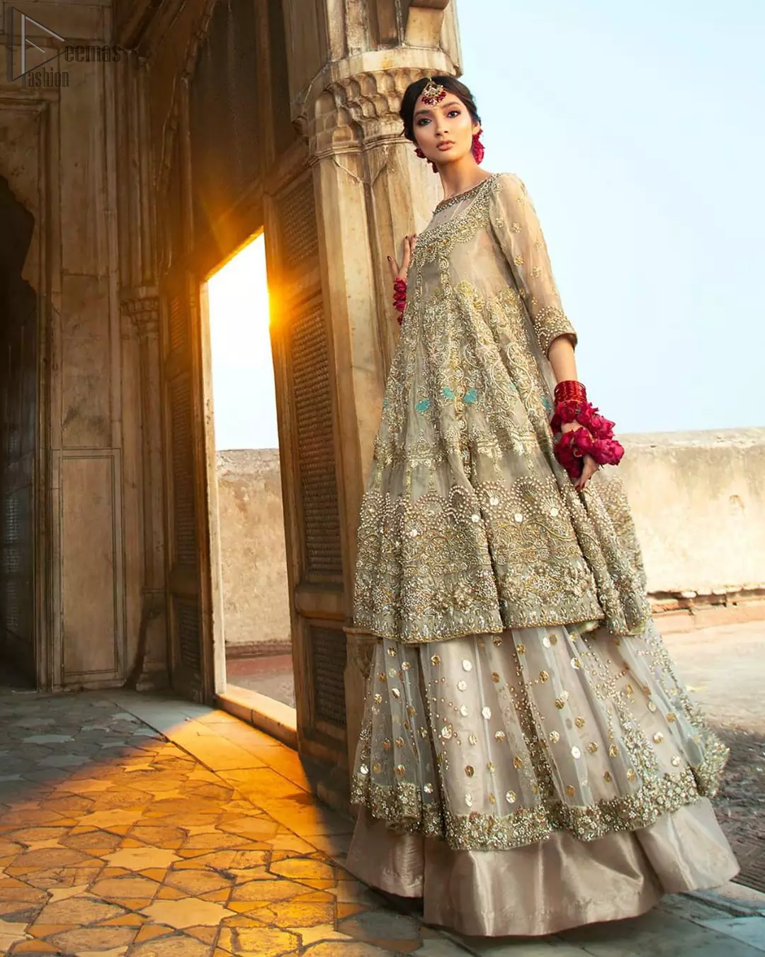 Pastel Green Double Layer Frock - Tea Rose Sharara. Fabulously stitched, Pastel Green double flared frock in maxi style is exquisite indeed. Fully embellished with tilla, dabka, sequins, pearls and silk thread embroidery. The frock body is entirely composed of pure organza with one part round neckline. Frock comes with three-quarter sleeves and it is concealed with a side zip closure. Tea rose pure tissue sharara with decently composed with fixed waist belt with side zip closure is one to wear on nikah or on a wedding day.