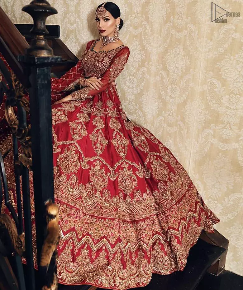 Poise, Beauty, and Charm. Feel pampered in this finely handcrafted celestial-inspired ensemble, deftly ornamented with intricate hand-embroidery. Fitted red blouse with cross-check pattern work and solid embroidery. Pakistani bridal dress comes with a large flare lehenga having multiple panelled embroideries.   Pure Organza dupatta has heavy four-sided borders and cross-checks pattern embroidery. 