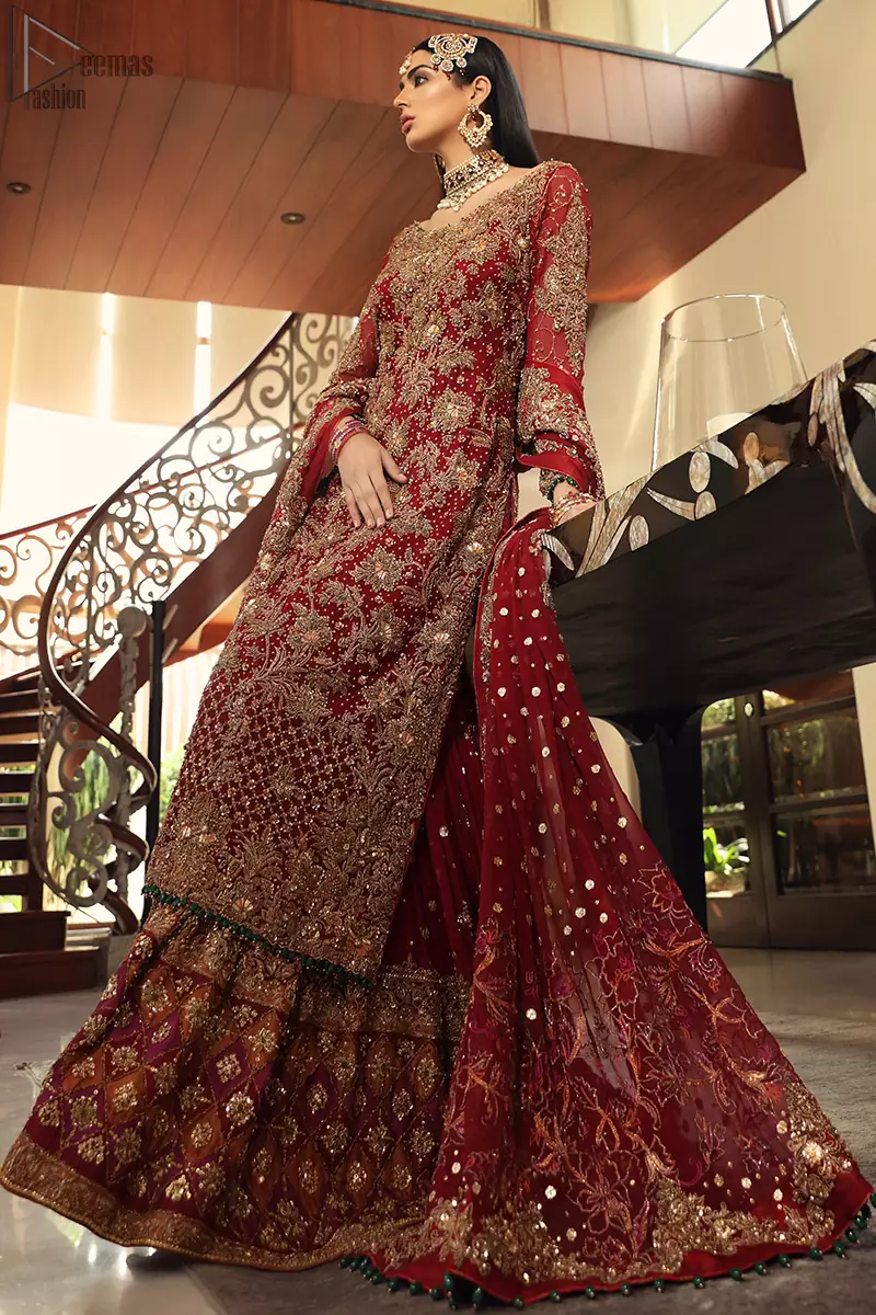 Maroon bridal wear long shirt, appliqued Gharara and matching heavily embroidered dupatta. We will make you believe in fairy-tales! Ethereal handcrafted luxe ensemble, fit for a princess glammed out with gorgeous layers of hand-embroidered details, timeless silhouette and dreamy embellishment. The outfit is finished with beautiful maroon organza gharara having appliqued embroidery below the gott. This colourful gharara having thick embroidery borders gives it a regal look.