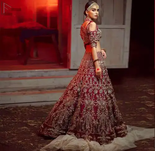 Maroon Pakistani bridal wear half blouse and lehenga comes with dupatta. Deep red half blouse choli along with same colour