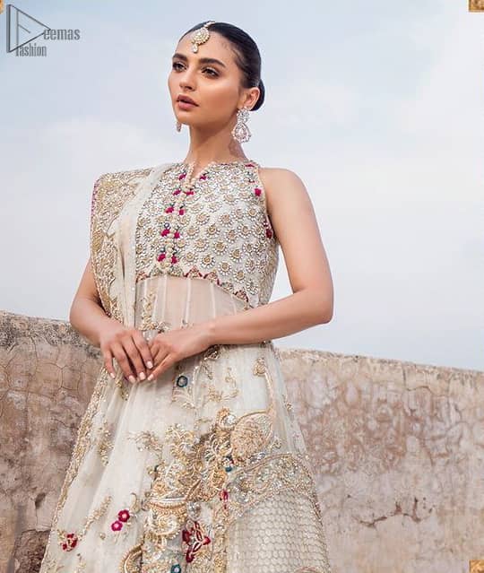 The new season is all about making a statement. It is an unforgettable look that will effortlessly take you from day to night this festive season. The bodice is fully embellished and the rest of the pishwas is ornamented with floral jaal with multiple color embroidery and thread work. The lehenga is more intensified with an embellished border with zardozi work on ivory canvas which instantly appeals to everyone’s attention. Dupatta is adorned with a delicate arrangement of hand-embellished geometric patterns with kora, dabka,sequins, pearls, crystal, and Swarovski all around the edges.
