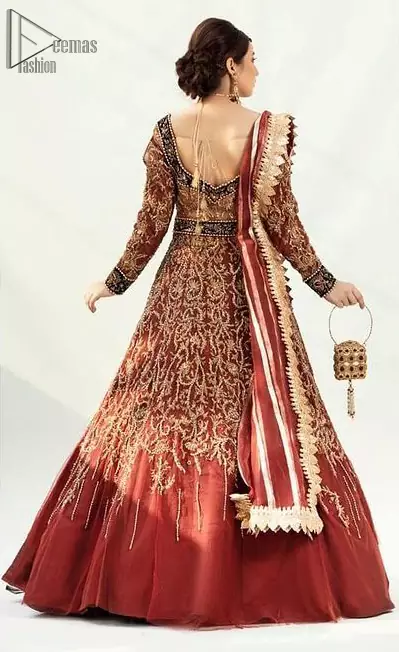 Dress up traditionally with Deemas Fashion's marvellous Burgundy Ball Gown. An exquisite full-sleeved gown followed by a marvellous churidar Pajama. This Maroon gown is made to perfection with splendid golden embroidery, beneath its beautiful sweetheart neckline. A net Dupatta completes the overall dress code and makes you ready for your Reception day. Pakistani Reception Wear Burgundy Ball Gown - Lehengha.