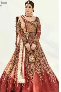 Dress up traditionally with Deemas Fashion's marvellous Burgundy Ball Gown. An exquisite full-sleeved gown followed by a marvellous churidar Pajama. This Maroon gown is made to perfection with splendid golden embroidery, beneath its beautiful sweetheart neckline. A net Dupatta completes the overall dress code and makes you ready for your Reception day. This dress has all the attractions required to have the public's attention on your big day. South Asian Reception Wear Burgundy Ball Gown - Lehengha.