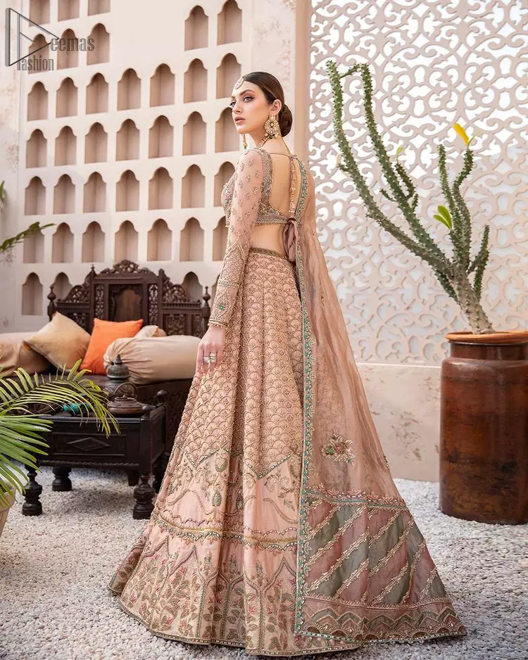 Pakistani Wedding Wear Peach Blouse Lehenga. DupattaThis breathtaking fit and flare wedding dress offers comfort without compromising on style. This nude peach colour is the perfect feminine and delicate shade with its meticulously crafted fabrication with gorgeous embroideries. The multiple colour embroidery The outfit comes with an embroidered belt. Adorned with sterling sequences and silver and crystal hand embellishments, it's a classic modern masterpiece!