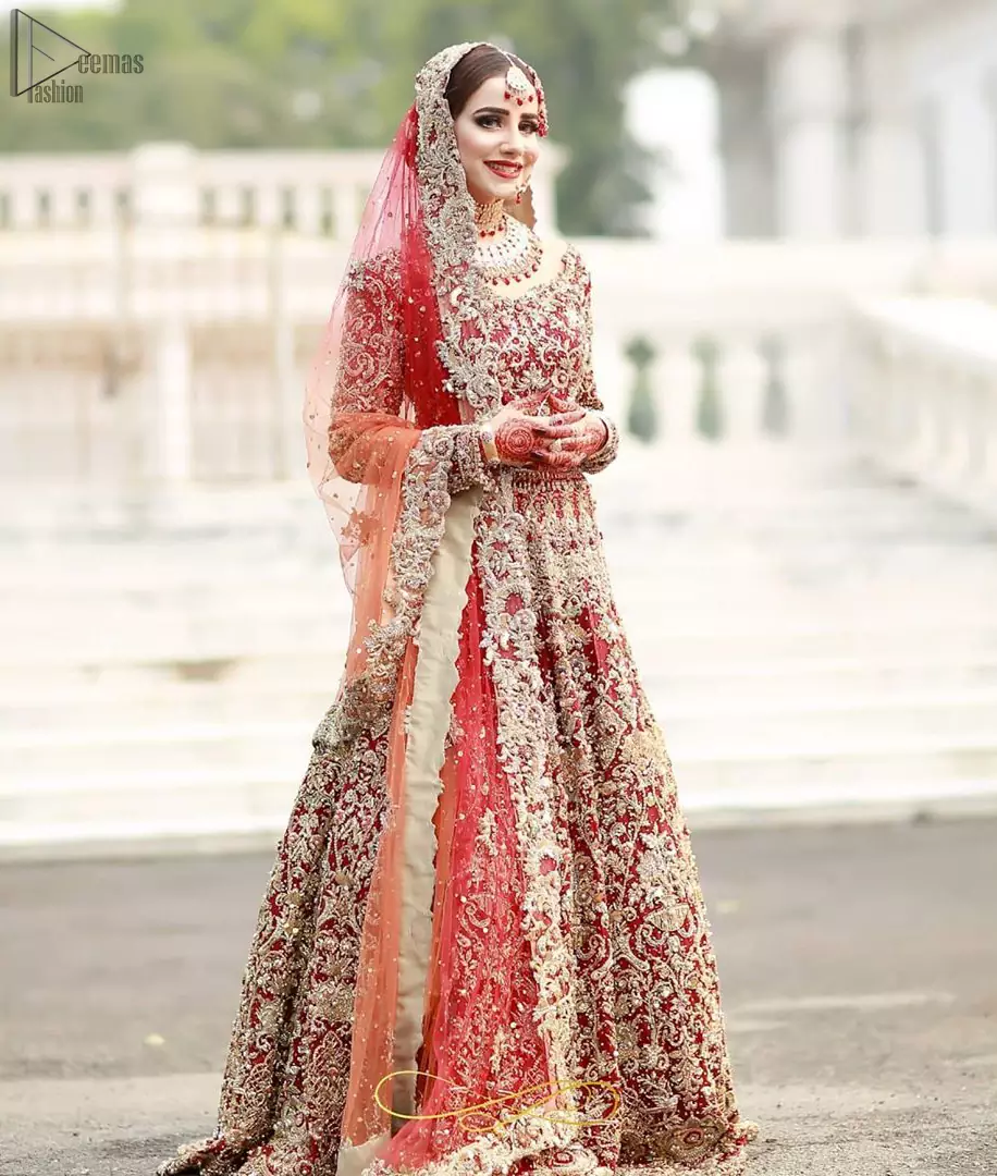 This bridal outfit is perfect for your unforgettable day. This exceptionally detailed dress is cut in a seductive fit and flare silhouette that’s sure to turn heads. Featuring a delicately embellished neckline highlighted with zardozi detailing and intricately embroidered borders. This technique gives our garments a unique look and helps to sustain a traditional craft carried out by skilled artisans across Asia. The lehenga is heavily laden with golden kora, dabka, tilla, sequins and beads work and also beautified with scalloped borders. Pair it up with heavily embroidered organza dupatta that gives the right amount of glamour to the outfit.