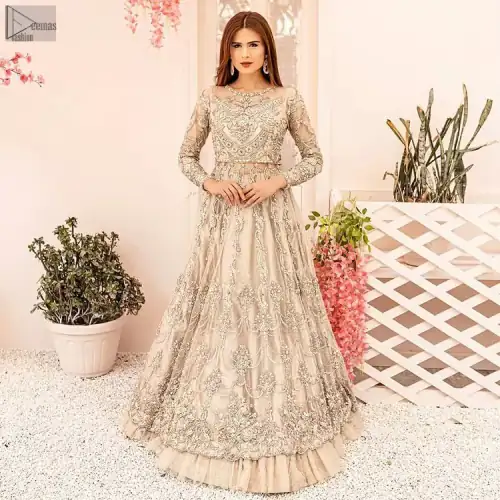 Enriched with magical sensations, this full-sleeved bridal wear features a distinctive, yet exceptionally stunning jewel neckline