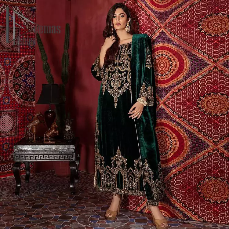 Create your own fantastic day with this bottle green velvet article that style serves for an elevated look. The shirt is flawless in bottle green colour with delicate antique golden work that includes kora, dabka & mukesh details that are artistically embellished to give a beautiful flow to the outfit.  Dupatta is like a shawl in velvet that blends both classical and contemporary trends that will make you swoon in it.