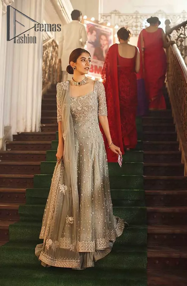 Exceptionally styled and symphonized stitching makes you gorgeous enough that it would surely make your big days remembering one. The Gray Pishwas Frock is a true beauty when it comes to the work of perfection. This Half Sleeves fit and flare attire is made to brighten up your persona with its finest adornments under its charming sweetheart neckline. It comprises gray crushed sharara and organza dupatta ornamented with a four-sided embellished border.