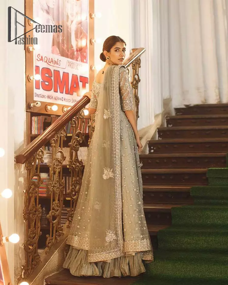 Exceptionally styled and symphonized stitching makes you gorgeous enough that it would surely make your big days remembering one. The Gray Pishwas Frock is a true beauty when it comes to the work of perfection. This Half Sleeves fit and flare attire is made to brighten up your persona with its finest adornments under its charming sweetheart neckline. It comprises gray crushed sharara and organza dupatta ornamented with a four-sided embellished border.