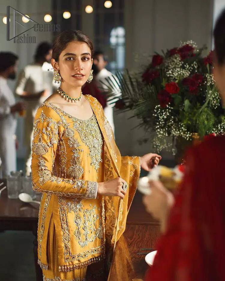 As we seek outside the wonders we carry inside us. So, to attain that wonders Demaas Fashion introduces Mustard short shirt and Sharara. A Short shirt featuring a stunning front, full sleeves, and remarkable embroidery on a round neckline, initiates the attractiveness of this dress. Further, the apparel displays light golden embroidery that brightens up its victorious look. Finish this look with an organza dupatta with an embellished border that increases the beauty of this outfit. Sharara is emphasized with intricate embroidery on the border and scattered floral motifs.