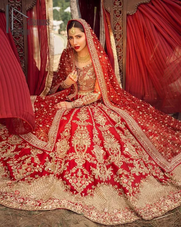 Make your moment memorable by being a dreamy lady in this red can-can lehenga boost with floral motifs. This dreamy can-can lehenga is adorned with golden kora, dabka, tilla, sequins and resham thread work which gave a perfect ending to this flare. In addition to this, the blouse is fully embellished with zardozi work. Finish the look with a red dupatta having four-sided embellished borders scattered with tiny floral motifs and sequins spray all over the ground.