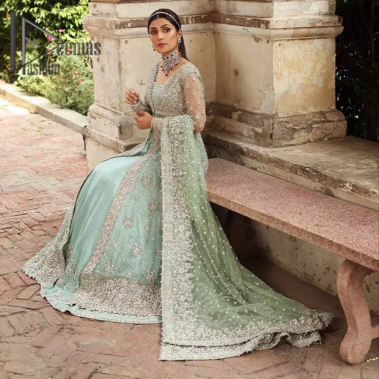 Stressed about your outfit on Walima? Deemas Fashion will save your day. Make your moments more memorable with our ice blue front open maxi that is adorned with silver tilla, kora, and crystal work to enhance the beauty of maxi. In addition to this, the beauty of the square neckline of the stunning maxi speaks itself on your day. It is synchronized with the lehenga that's border is as pretty as look in the picture. Finish this look with dupatta that personifies the delicate embroidery on four sides and sequins detailing all over just to save your memorable day and give you fairy look.