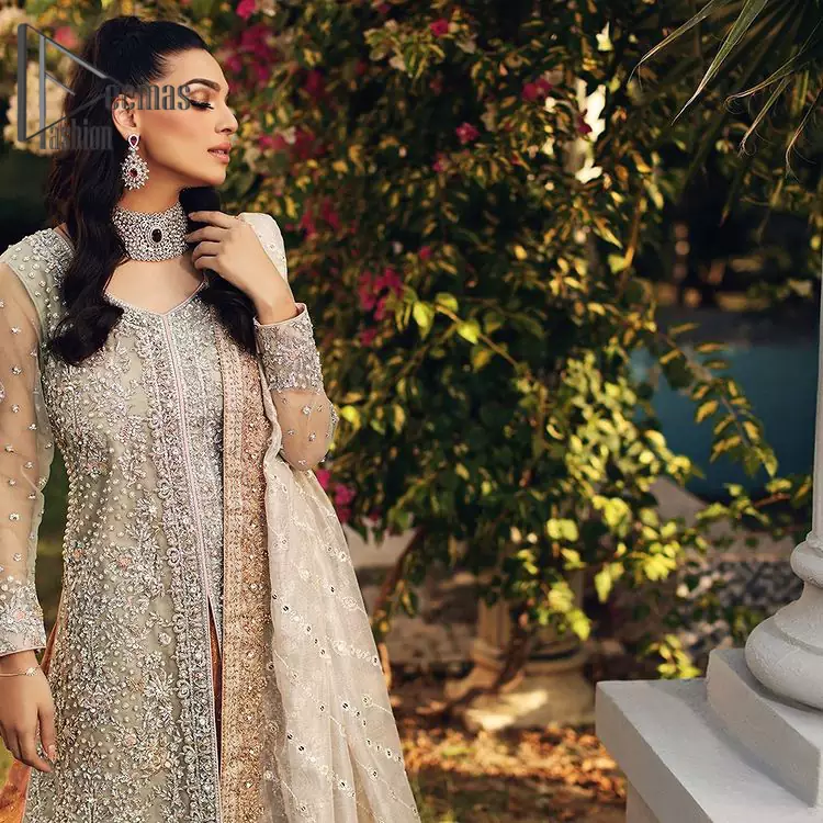 It's time to stock up your eventry wardrobe with the ensembles that have everyone hooked. Your mini fashionistas got stunned in this mint green and rust attire. Just look at the super detailing of a mint green front open shirt that is ornamented with silver embroidery that includes tilla, kora dabka, and crystal work. It is further enhanced with a Round neckline that gives so soothing display. It is coordinated with Rust sharara which border is sprinkled with silver embroidery and sequins spray all over that looks just priceless at any party. End up this attire with an ivory dupatta with four-sided embellished lace.
