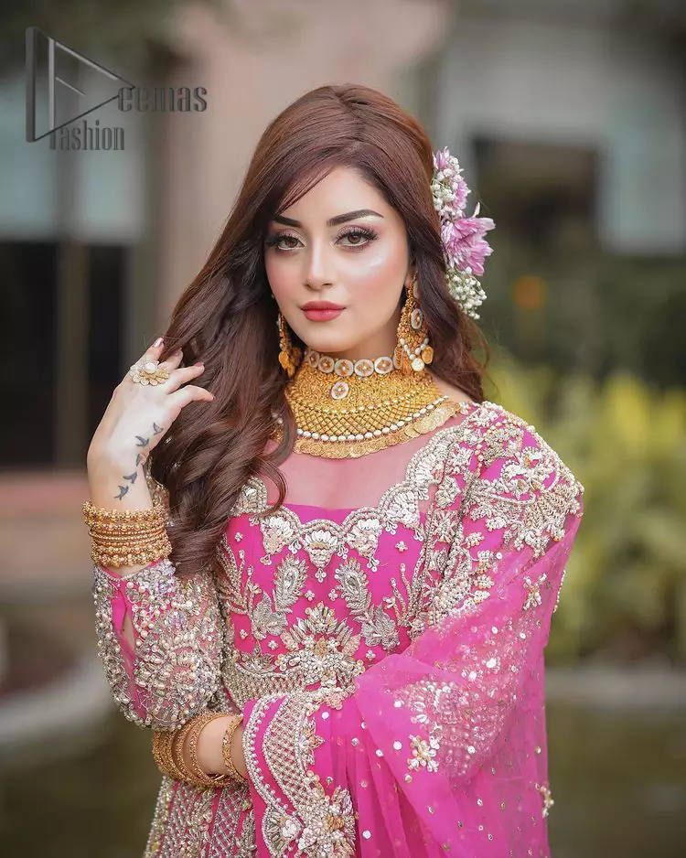 A color splash, a floral dream. Let your energy shine with this pink outfit. Make a dramatic entry with pink scalloped pishwas that's full sleeves look super-duper amazing when combine with Jewel neckline. It is streaking with the finest silver embroidery that count in tilla, kora, dabka, and crystal work to give you enthusiast look. Further, this scalloped pishwas is coordinated with Pink dupatta that is adorned with four sided borders and sequins spray all over to give you shiny energy on any party.