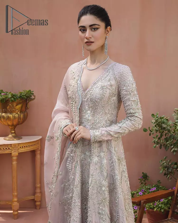 A true epitome of elegance. Confected ever so beautifully with the oyster pink colour palette and eye-catching embroidery. The ouster pink maxi is splendid just because of its multiple colour embroidery which is involved with tilla, dabka, kora and pearls. Further, it is prominent with its V shape neckline that grants pleasure to you on your walima day when combine with full sleeves. Complete this oyster pink outfit with a dupatta that is ornamented with embellished border and sequins spray just to fulfil your dream.