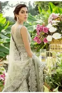 Dare to wear, Oh so bling and slaying like never before. It's an outfit of power and glam. The pistachio green maxi is a breathtaking assortment of sequins, pearls and crystals. The V shape neckline has enhanced the beauty of this pistachio maxi which is attractively combined with a sleeveless style. Further, it is prominent with silver and light golden embroidery. Pair up this maxi with the same colour lehenga. Complete this article with a dupatta which is intensified with intricate embroidered border and sequins spray all so you can steal everyone's heart on your walima day.