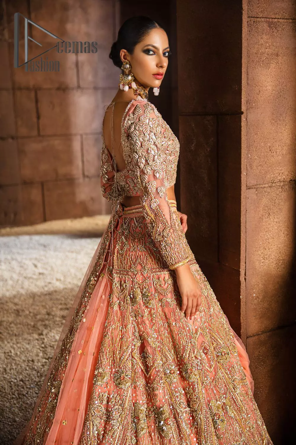 Soft-touch of peach into fresh buds blooming in the garden. This peach article is a perfect pick for your Walima day which is starting with a peach blouse and is heavily ornamented with golden tilla, kora and zardozi work to enhance the fresh look of a bride. In addition to this, it is highlighted with V shape neckline and combined with full sleeves to glow like the flower in the garden. It is paired up with the same colour fluffy lehenga which is enhanced with the bottom frill to fulfil the dream of every girl.  Complete this article with the same colour dupatta which is embellished with four-sided Kiran. 
