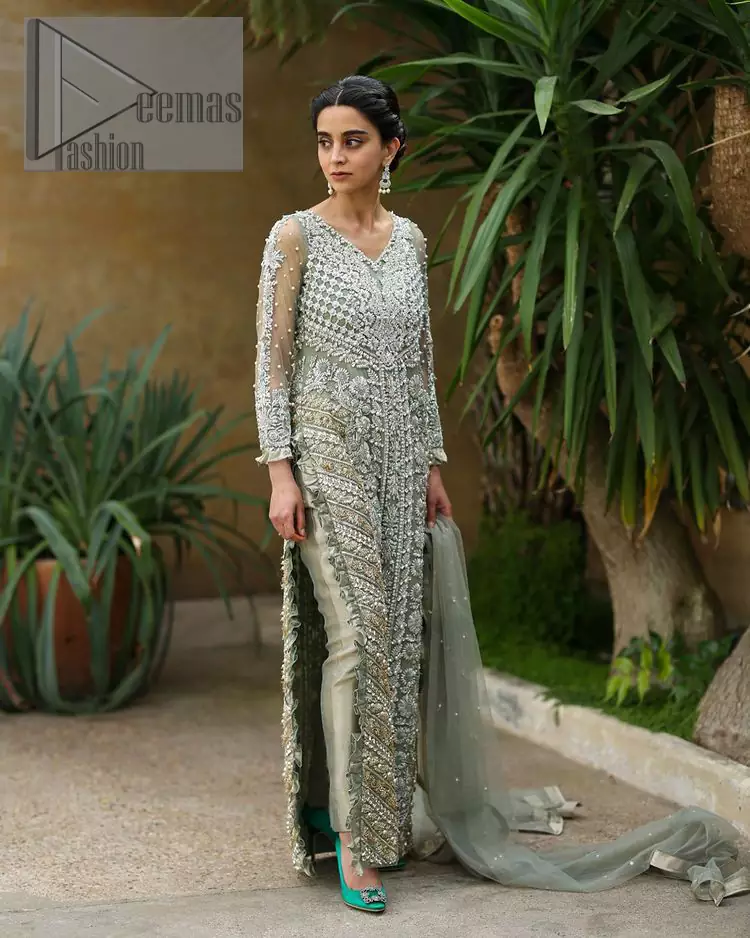 The subtle but powerful action.DeemasFashion presents pastel green outfits just to grant you modern, light and easy-breezy vibes at any party. The floor-length shirt of this article is attractively adorned with silver embroidery which is highlighted with kora, dabka, tilla and crystal work. In addition to this, the V shape neckline and full sleeves enhance the beauty of the article as you are the star of the party.  it is coordinated with the same colour plain trouser that balances the look of the article. Finish this pastel green dress with the same colour dupatta that is adorned with sequins spray all over as you can steal everyone's heart on any occasion. 