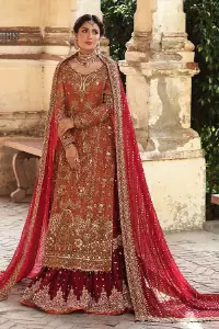 Wondering what an aesthetic bridal attire looks like? The beauty in red makes you go gaga over your look and you cannot stop snowing over you. Wearing the rust long shirt on your big day that is marvellously adorned with kora, dabka, and sequins work. Furthermore, the round neckline is also beautifully decorated to enhance the beauty of the outfit. It is synchronized with a red lehenga that has sequins sprayed all over to give you a crazy look as well. Finish this look with a red dupatta that has four-sided embellished borders as well.