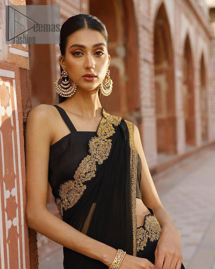 Every saree tells a story! Black is always the reason behind any smile at parties. DeemasFashion also presents a formal saree in black that you can wear at any function or party. The black blouse having sleeveless and strap neckline gives you so soothing and romantic look. Further, the simplicity of the blouse enhances the beauty of the outfit. It comes with a pure black saree which is ornamented with golden embroidery. It is highlighted with tilla, kora, and dabka work on borders. The pallu of the saree is also prominent with golden embridery. 