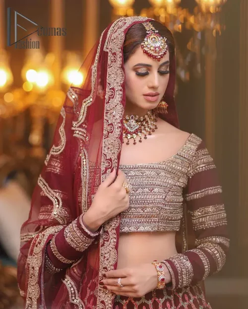 Attain your expectations on your big day with this dress. The classically vibrant combination of red and gold is a