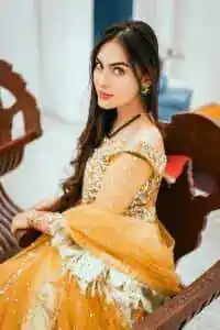 Mustard is just associated and boosts your Mehandi.  Presenting a dreamy mustard frock with a heavily embroidered bodice on a silver base. The bodice is further enhanced with handwork that includes crystal, tilla, kora and dabka work. Furthermore, the boat shape neckline and tiny work on full sleeves have the super style just to boost your day. The bottom is decorated with artistic embroidery that is adding glam to it. The Mehandi look is completed with an artistically crafted frilled lehenga which frill borders displaying the traditional hint of charm. It is coordinated with a dupatta in the same colour that is embellished with four-sided borders as well. 