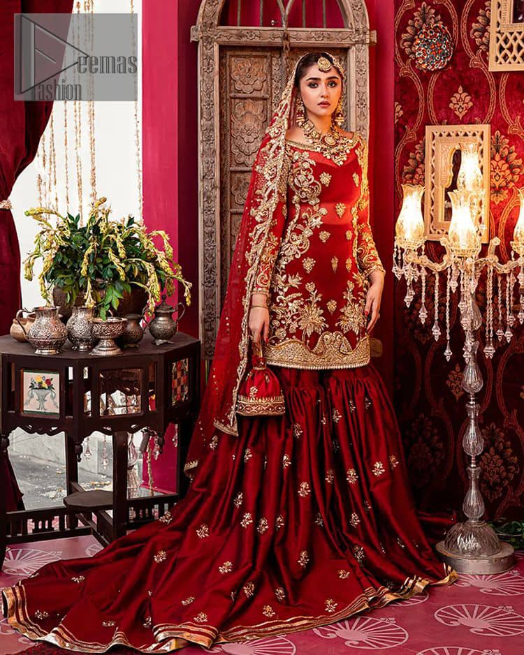 Bride love is in the air! DeemasFashion presents a red shirt rendered with golden embroidery and is enhanced with the magic of Resham, pearls, Sitara, tilla and dabka to complete the feeling of your Big Day. The shirt is emphasized with boat shape neckline and full sleeves to make your day super romantic. In addition to this, it is coordinated with red back train gharara which is intimately embellished with golden floral motifs as well. To finish this article, the last but not least piece comes that is the dupatta which is adorned with four sides heavy borders and sequins spray all over to explain the love of the bride.