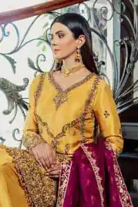 Yellow has the ability to take all the attention. Deemasfashion presents a yellow and pink outfit for your Mehandi. Starting this article with a yellow shirt that is handsomely decorated with golden embroidery and prominent with tilla, dabka, kora and zardozi to make your look super unique and perfect. Further, the following shirt is paired up with yellow straight trousers whose border is again rendered with golden embroidery. Complete this article with a magenta dupatta embellished with intimate border embroidery to gain all the attention of the event.