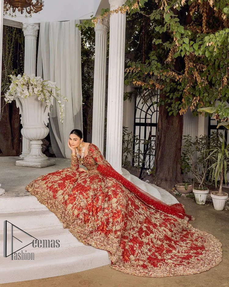 Feels just redish on your Big day to make your day lovely and romantic. DeemasFashion presents this Pakistani reception wear for you in bright red colour which begins with a flared back train maxi. The maxi is attractively and laboriously adorned with golden embroidery that enhances tilla,dabka, kora and Kundan. In addition to this, the boat shape neckline intensifies the beauty of this Pakistani reception wear when comes with full sleeves. The flared back train of the maxi is also heavily embellished. Complete this article with a dupatta in the same colour which is adorned with four-sided borders and tiny floral motifs, sequins spray all over to make you fresh on your Big day.