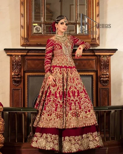 Happiness and confidence are the prettiest things that are associated with your wedding outfit. DeemasFashion presents this Pakistani reception wear in deep red colour. The deep red heavy maxi of this Pakistani reception wear is gorgeously adorned with a golden embroidery which is further enhanced with tilla, dabka, and kora. The boat shape neckline speaks of the boldness of the outfit. The following maxi is paired up with maroon sharara whose border is also embellished. Out and out of this Pakistani reception wears a dupatta in the same colour which is adorned with a four-sided border. Further, it is decorated with sequins sprayed all over.