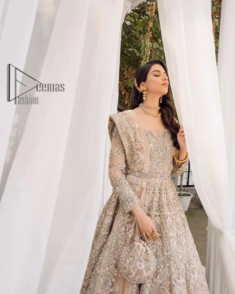 Begin your new life by wearing a dreamy nikah outfit of deemasFashion. Introduce this nikkah outfit with a light fawn frilled heavy maxi that is laboriously hand-rendered with silver and the same colour embroidery that enhances tilla, dabka, kora and crystal. The boat shape neckline and full sleeves of this maxi also add memorable beauty to your amazing Qabool Hai moment. The maxi of this nikah wear is systemized with a dupatta in the same colour which is ornamented with four-sided borders and sequins sprayed all over to enhance the attractiveness of the nikah outfit.