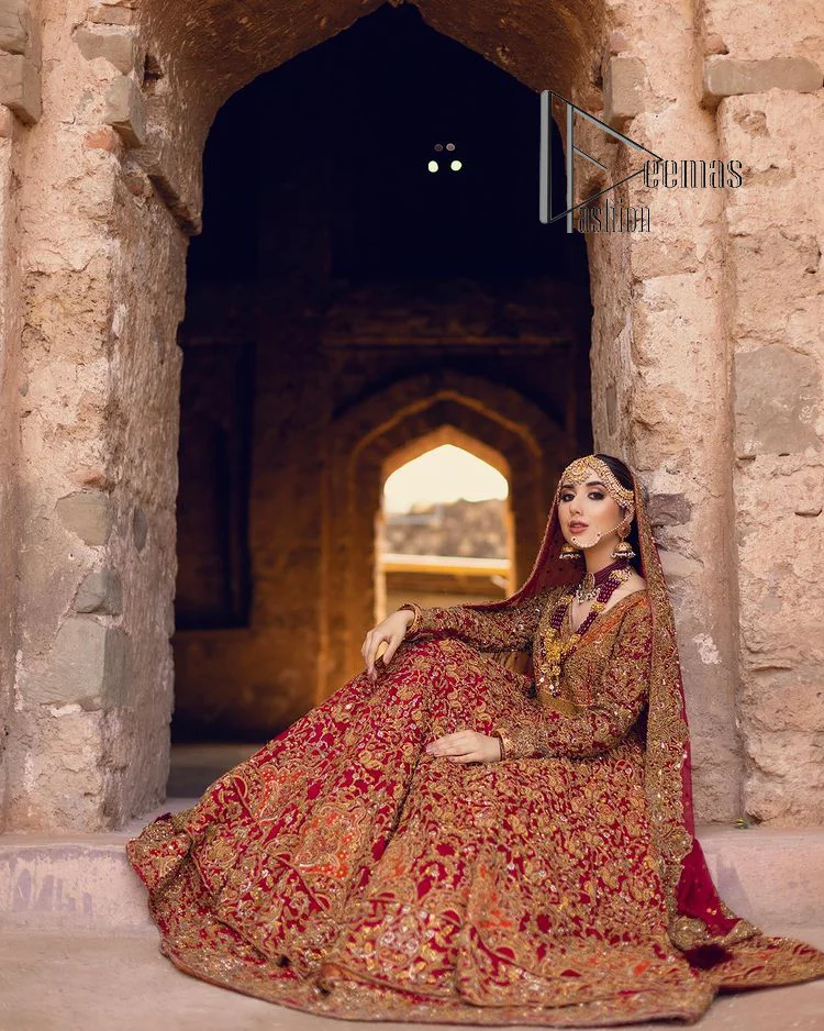 Happy is the bride the maroon shines on. Initiate this Pakistani reception outfit with a maroon heavy Anarkali which is sumptuously hand-rendered with golden embroidery that includes tilla, dabka, kora and Kundan. The V shape neckline of this Pakistani reception outfit exquisitely comes with full sleeves. It is paired up with rust farshi lehenga whose border is again adorned with golden embroidery. Finish this Pakistani reception outfit with a dupatta with a four-sided embellished border and sequins sprayed all over to put a maroonish shine on your big day.