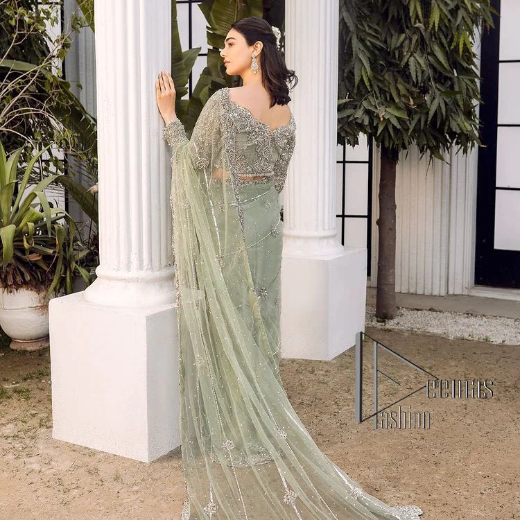 You go girl. Get you a handsome outfit that will wear matching robes. DeemasFashion presents this pistachio green saree to make you memorable in any event. It begins with a pistachio green blouse which is heavily ornamented with silver embroidery that magnifies tilla, dabka, kora and Zardozi. Further, the full sleeve style also enhances the beauty of the bridesmaid outfit when comes with boat shape neckline. Paired this blouse with a handsome and laborious saree whose scalloped border is embellished with a four-sided border and sequins spray all over to match your vibe.
