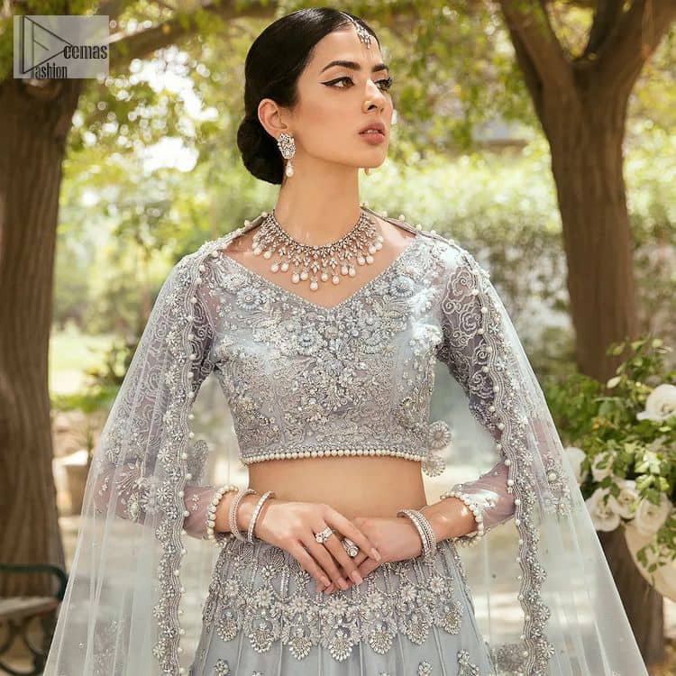 The magic of luxurious romantic outfits, giving you love at your Walima. The outfit defines the endless beauty of the immaculately produced pieces with intricate silver and golden embellishments, which are further magnified wth tilla, dabka, kora, Kundan and crystal. The full sleeve style of the blouse along with V shape neckline just gives you a unique way of artistic look. It is systemized with frilled lehenga which is heavily embellished with floral patterns to make your day more charming and delightful. Complete this article with a dupatta which is embellished with a four-sided border and ting floral motifs all over that are a dream of someone's special moment.