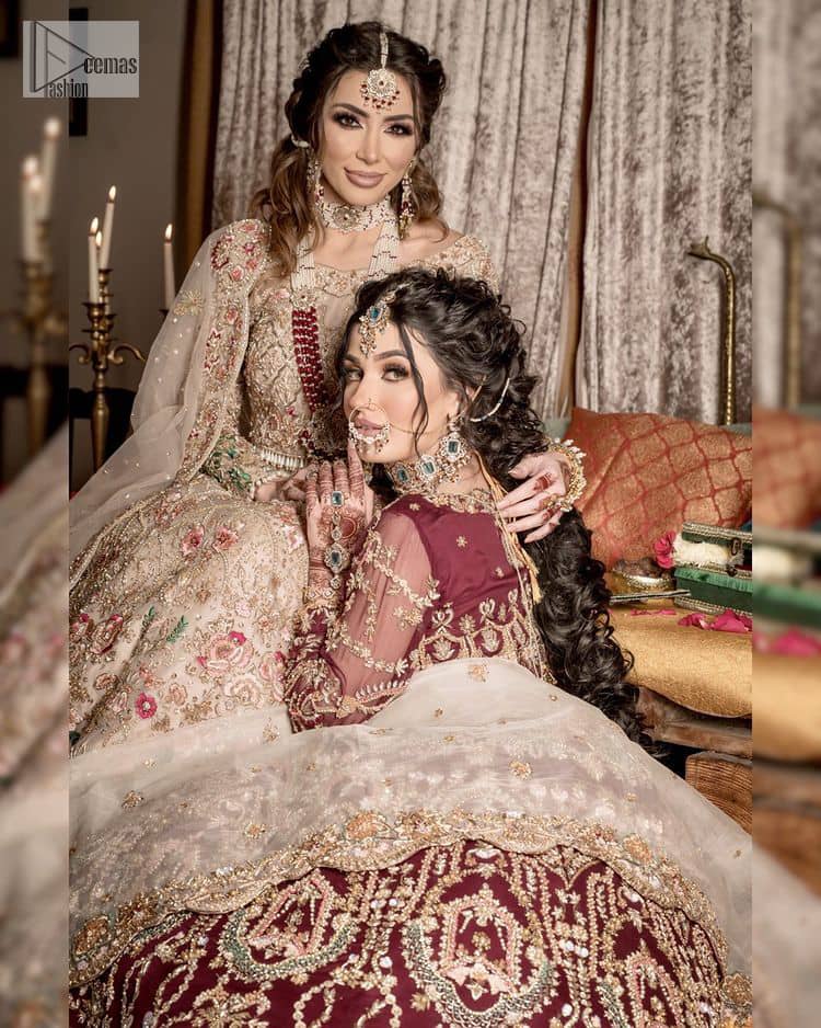 Take your style up a few notches in this elegant reception piece. A pure organza maroon fluffy lehnga is beautifully hand-rendered with golden embroidery and enhanced with  tilla, sitara, pearls, dabka and zardozi work. It is paired up with a blouse choli with tilla motifs on the full sleeves along with boat shape neckline to make your Big day astonishing and remarkable. The ivory organza dupatta has a four-sided embroidery adorned with pearls and Sitara and is framed with a scalloped style.