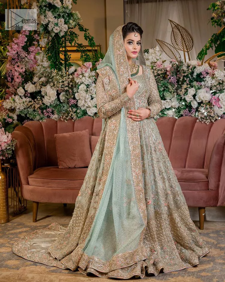 Unique embroidery designs to add some sparkle to your style on your Nikah! Light blue angrakha maxi with delicate multiple colour embroideries and intricate hand embellishments of tilla, dabka, kora, Kundan and crystals on the classic silhouette. Designed to flaunt your best features, the full sleeves carry beautiful embroidery with a square neckline. The following maxi along with the back train lehenga gives this outfit a unique look. Paired with a dreamy dupatta framed with embellished borders, this look is the epitome of ethereal and easy elegance.