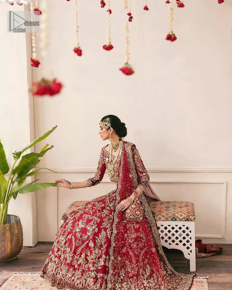 This outfit is a stand-out look for the Pakistani reception, this ensemble consists of a bright red-hued lehenga choli. This light golden embroidery is done with dense handsome work with the detailing of tilla, dabka, kora, zardozi and stone. The boat shape neckline of the following scalloped blouse intensifies the overall beauty of the outfit. Further, the beautiful floral patterns on three-quarter sleeves make this blouse super charming and ten times attractive. It is teamed up with can-can lehenga in the same colour that is ideal for the brides who want to be a queen on her Bug day. The outfit is paired with a dupatta heavily embellished all around the border, with a centre spray of sequins.